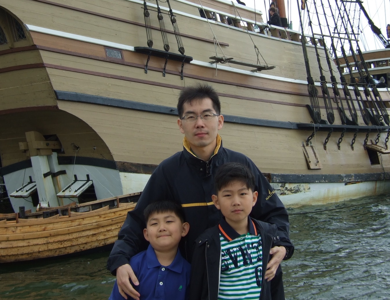 Dad and sons in front of Plymouth